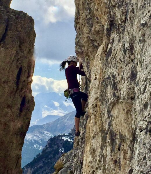 Julie Lorraine rock climbing in Italy before chronic illness.
